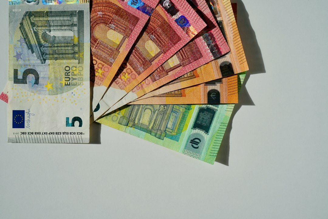Billets et pièces en euros illustrant la pression économique sur la monnaie européenne